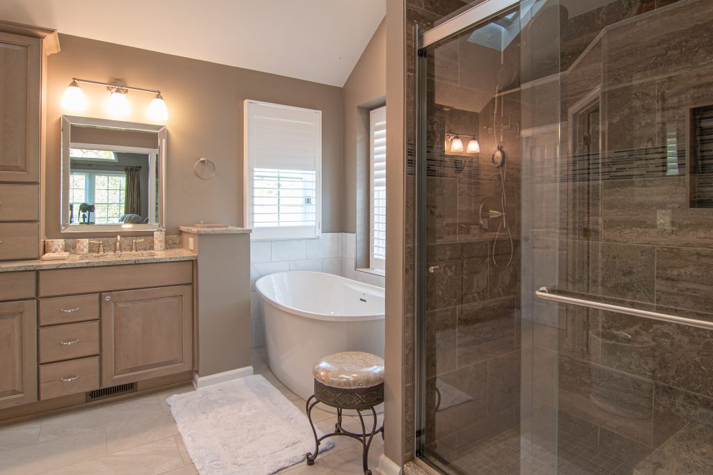 Gibsonia Transitional Bathroom with Herring Bone Floors, Painted Wood Cabinets and Quartz Counter Tops.
