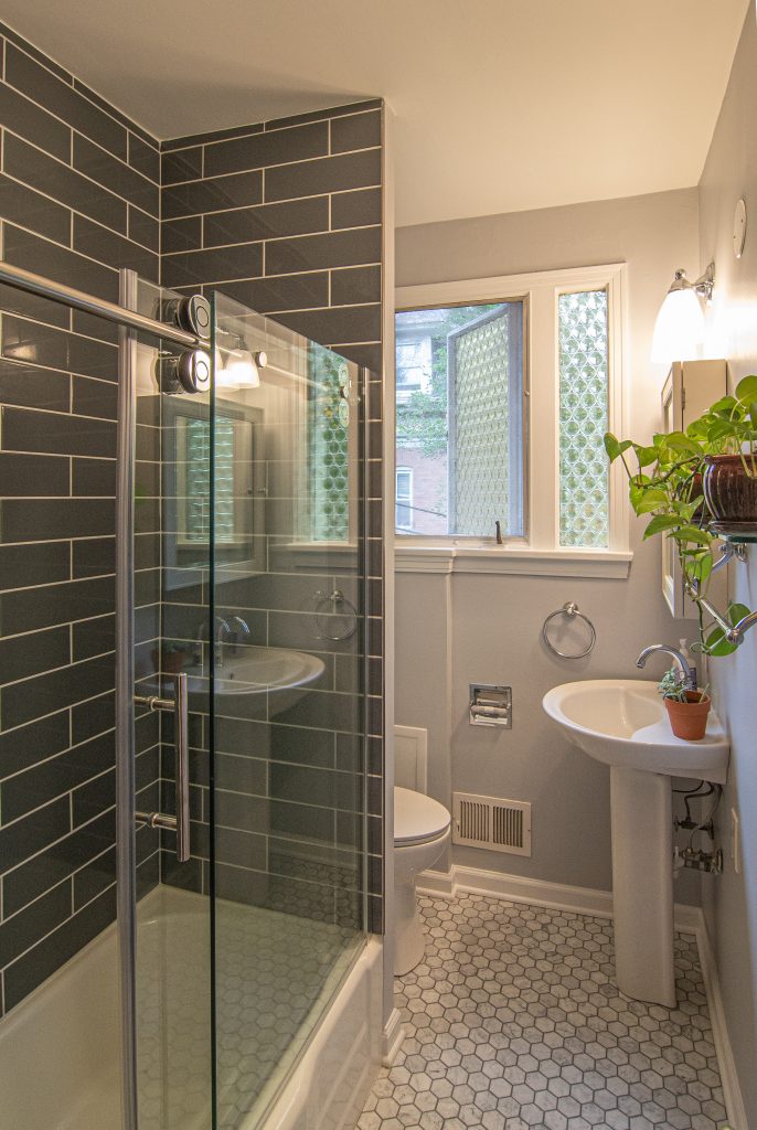 Traditional style bathroom using cold tones accented by the use of hexagon tile on the floor.