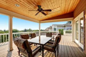 Large wooden walkout deck with flat roof extension and comfortable seating arrangement. Northwest, USA