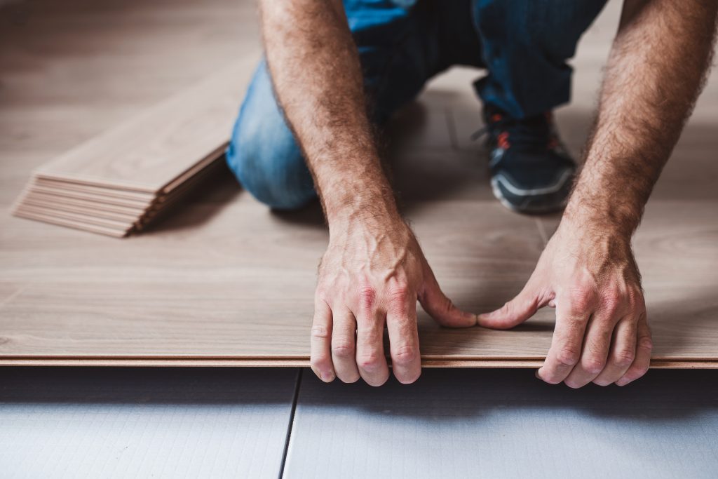 Picture of a technician installing new vinyl flooring.