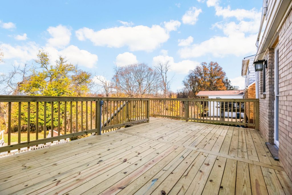 Picture of a wooden Mars, PA, deck with a staircase leading down to a driveway.
