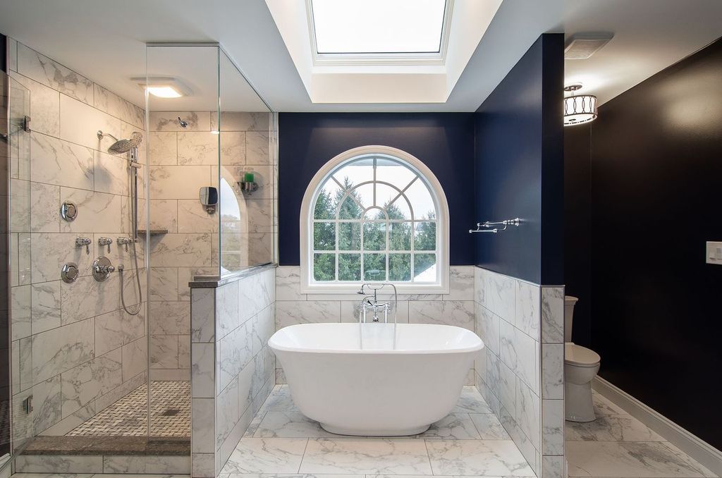Picture of a modern Upper St. Clair, PA, bathroom featuring a freestanding bathtub and a pop of royal blue paint.