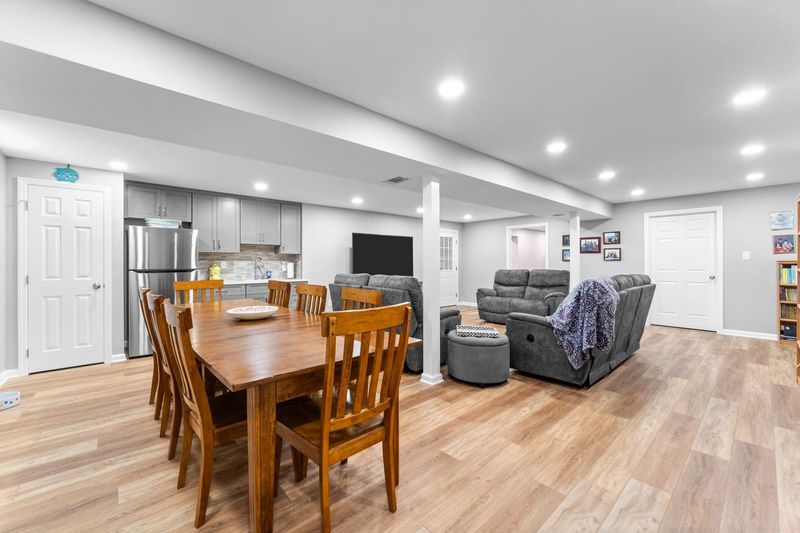 This Squirrel Hill Basement Boasts a Warm Living Space, a Wooden Dining Table and a Kitchenette for That Cozy Retreat Feel.