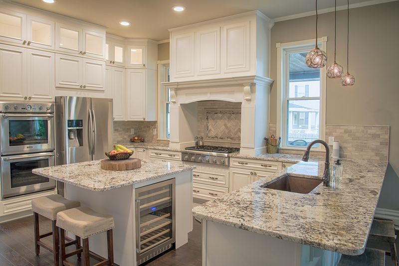 Traditional Squirrel Hill Kitchen Featuring Fluid Limestone Backsplash with Glass Mosaic
