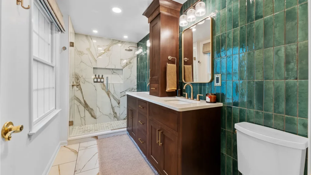 This Bethel Park Bathroom Features a Sophisticated and Rich Design with a Balanced Blend of Textures and Color. Overall, the Space is a Blend of Classic and Modern Elements, Creating a Luxurious Atmosphere with a Bold Color Palette.