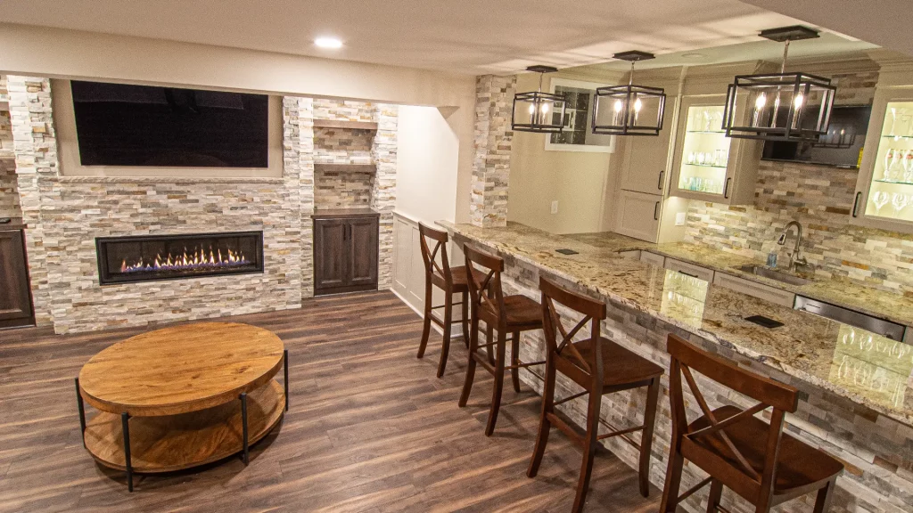 Modern Bethel Park Basement Showing Warm Colors, Straight Lined Cabinets and Stacked Stone.