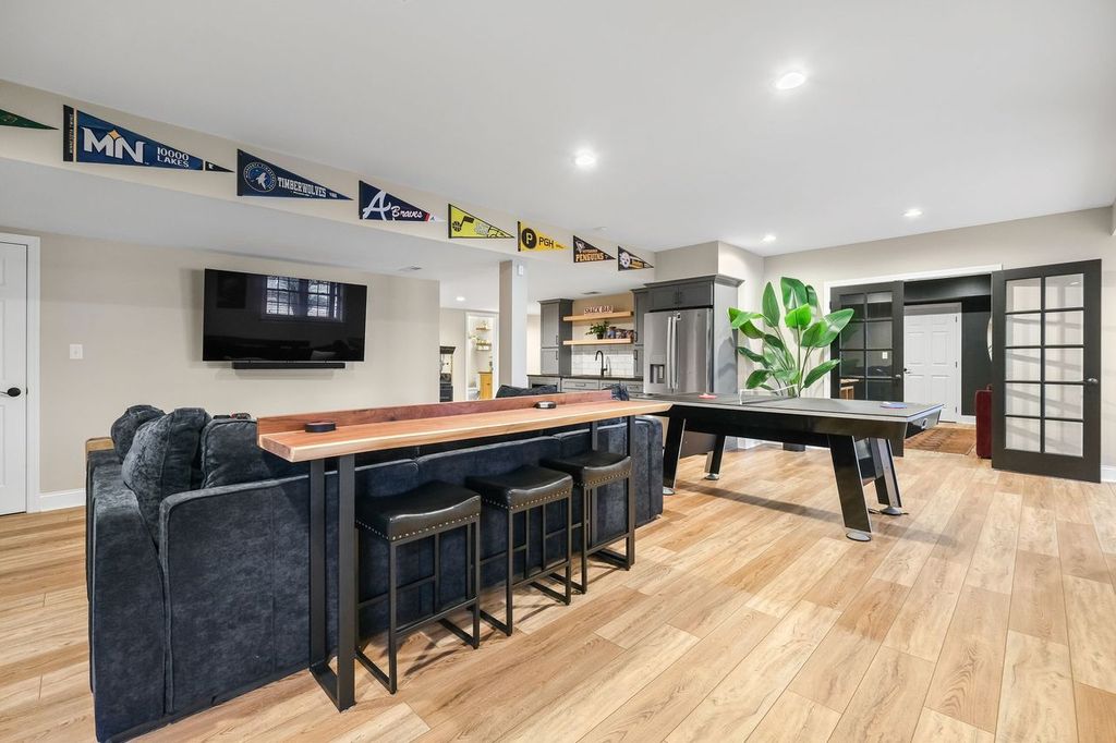 Modern Pittsburgh Basement Remodel Featuring Kitchenette and TV Area Create a Cozy and Inviting Spot for Socializing or Unwinding.