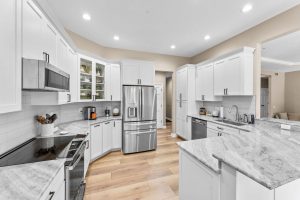 The Light-Colored Wood Floor Complements the Bright and Airy Feel, Creating a Sophisticated Space in this Pittsburgh Kitchen Remodel.
