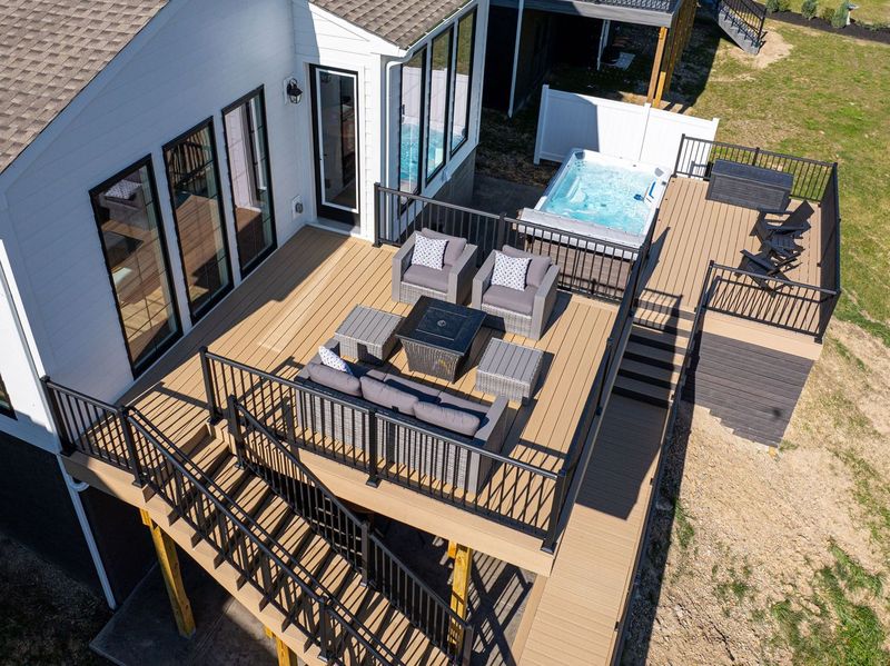 Luxurious McCandless Two-Level Deck Showcasing a Hot Tub and Patio Furniture, Offering a Tranquil Outdoor Living Space