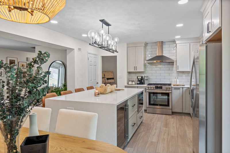 This Franklin Park kitchen boasts a streamlined, modern design with white cabinets and stainless steel appliances.