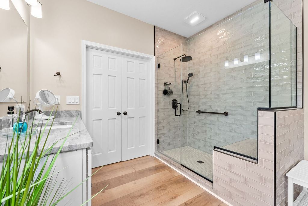 Neutral Gibsonia Master Bathroom Showcasing a Stylish Walk-In Shower with Glass Enclosure, Featuring Oil Rubbed Bronze Fixtures.