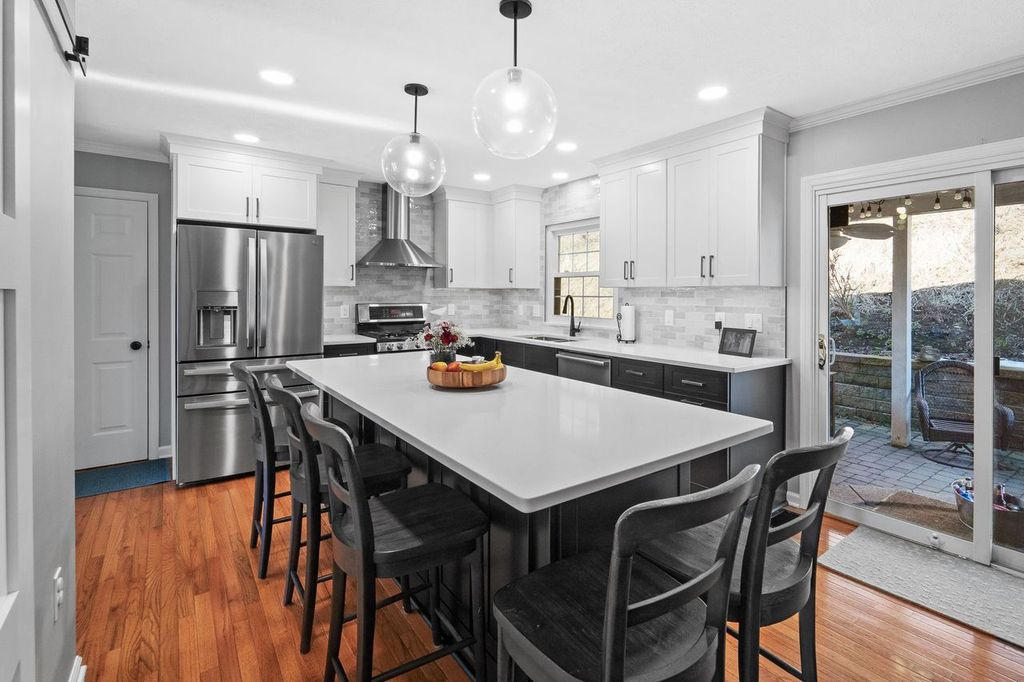 The Overall Design of this Cranberry Kitchen is Clean and Modern, Creating a Bright and Inviting Atmosphere.