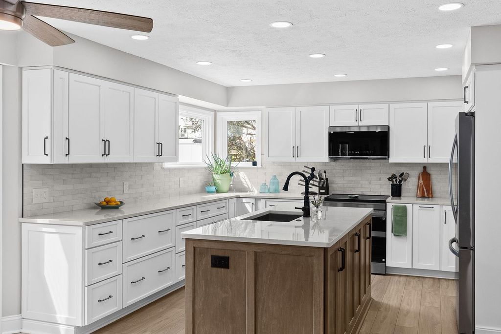 Transitional Style Bethel Park Kitchen with White Shaker-Style Cabinets Contrasted with a Modern Dark Wood Island Blending Classic and Contemporary Elements to Create a Timeless Look