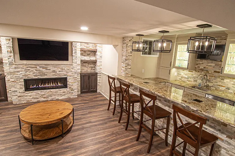 Modern Cranberry Basement Showing Warm Colors, Straight Lined Cabinets and Stacked Stone