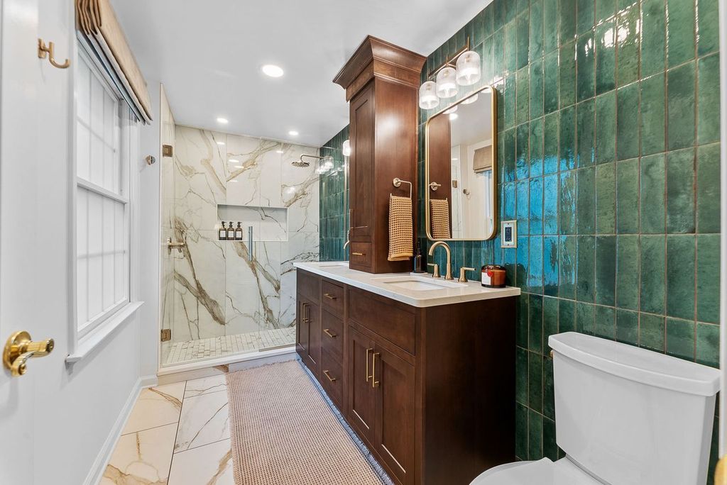 This Upper St. Clair Bathroom Features a Sophisticated and Rich Design with a Balanced Blend of Textures and Color. Overall, the Space is a Blend of Classic and Modern Elements, Creating a Luxurious Atmosphere with a Bold Color Palette.