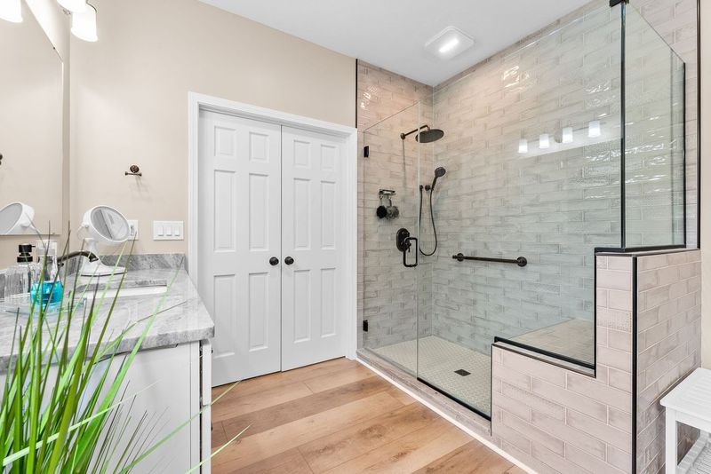 Neutral O’Hara Township Master Bathroom Showcasing a Stylish Walk-In Shower with Glass Enclosure, Featuring Oil Rubbed Bronze Fixtures.