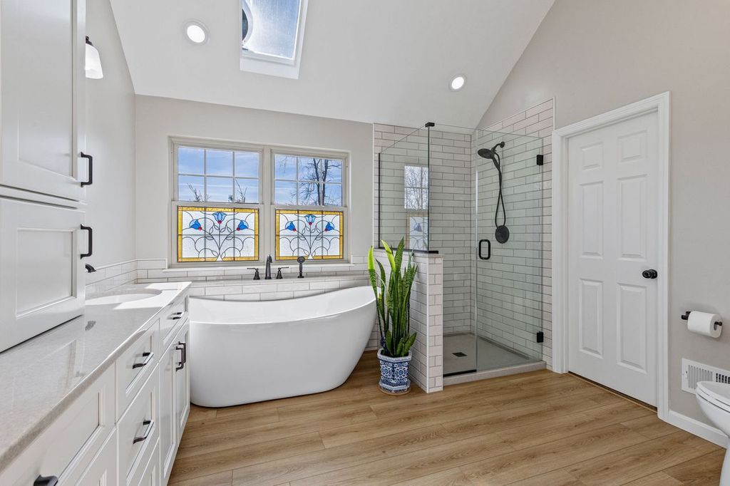 This Modern Farmhouse Sewickley Master Bathroom Features Soft Gray Subway Tile, Frameless Glass Shower and Matte Black Fixtures Giving this Space a Welcoming, Spa-like Vibe.