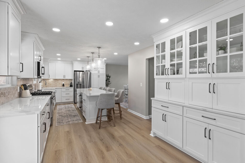 Modern Transitional Coraopolis Kitchen Featuring White Shaker Cabinetry, Light Quartz Countertops, Warm Luxury Vinyl Flooring and a Neutral Backsplash