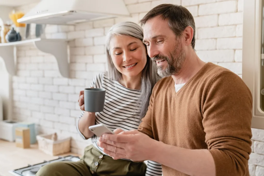 Homeowners reviewing remodeling ideas together in their kitchen.