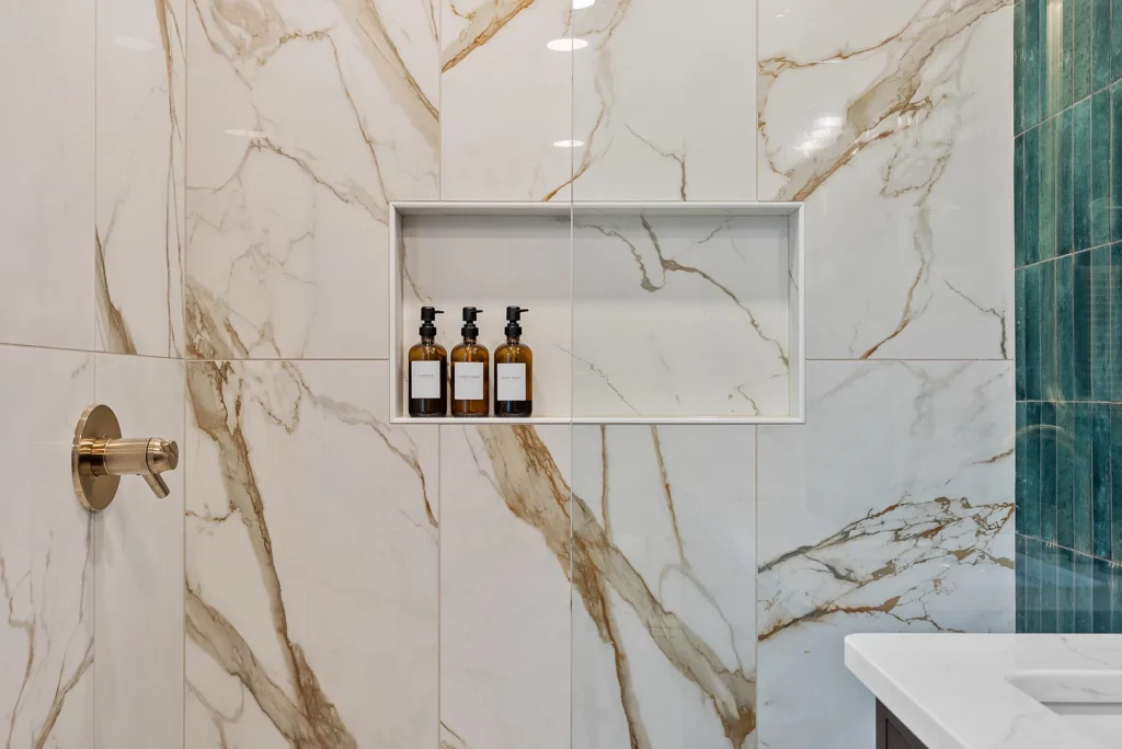 Modern Franklin Park Master Bathroom with Emerald Green Stacked Vertical Tile Accent Wall, Medium Brown Shaker-Style Cabinets and Cream and Gold Shower.