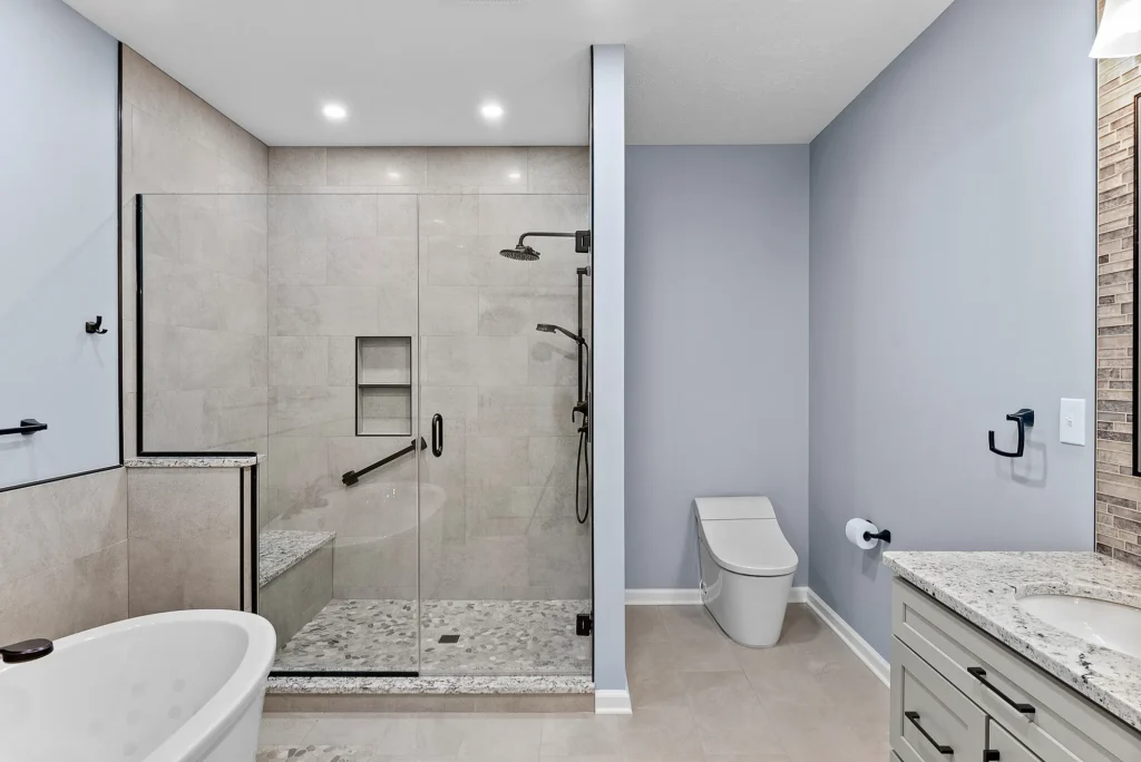 Contemporary Squirrel Hill Master Bathroom with Modern Spa-Inspired Style Featuring a Freestanding Soaking Tub with Sleek Dark Fixtures and Frameless Glass Walk-In Shower