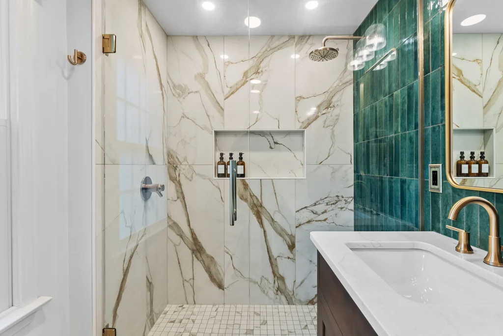 Modern Franklin Park Master Bathroom with Emerald Green Stacked Vertical Tile Accent Wall, Medium Brown Shaker-Style Cabinets and Cream and Gold Shower.