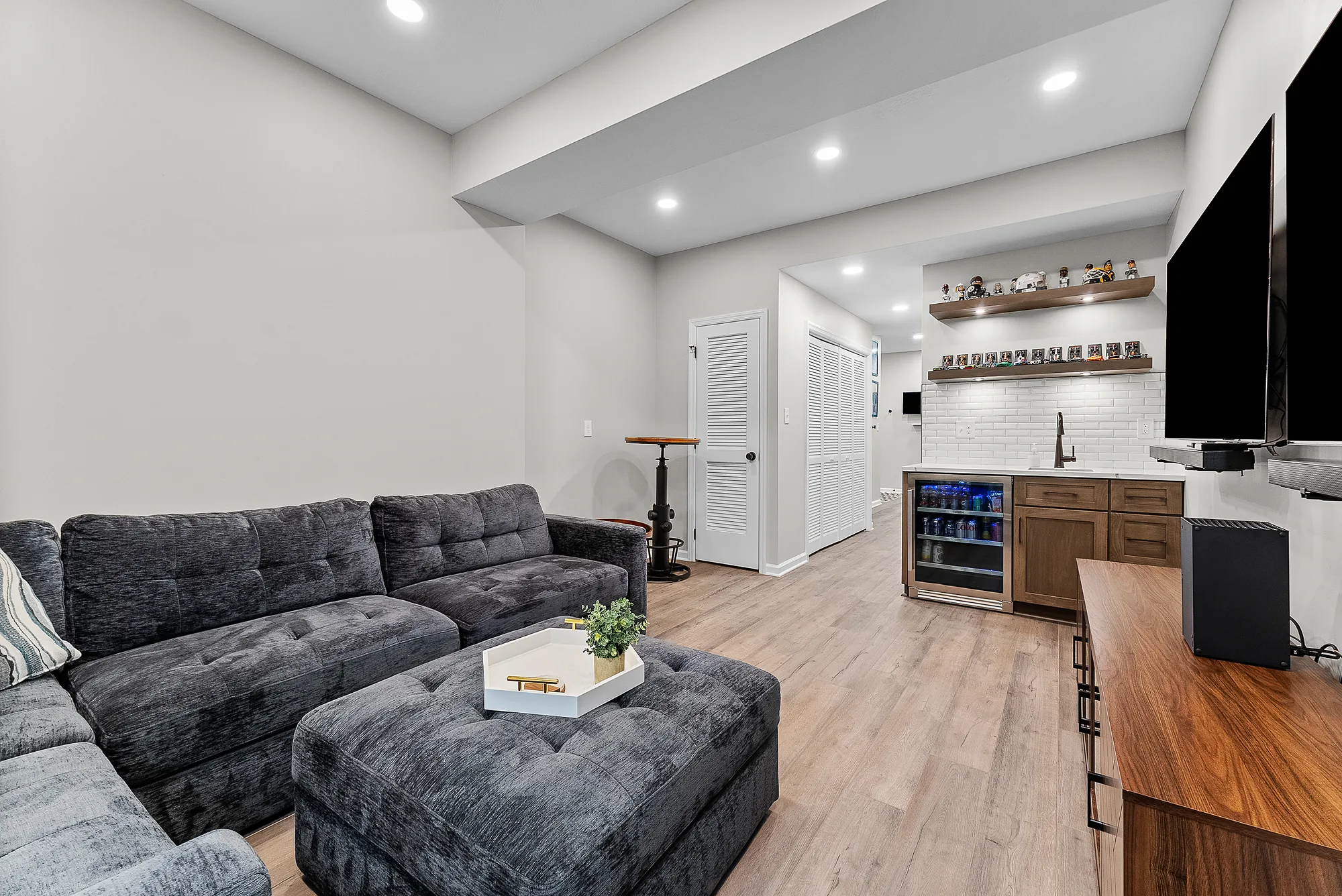 Stylish Wexford Basement Featuring a Cozy Multifunctional Entertainment Area.