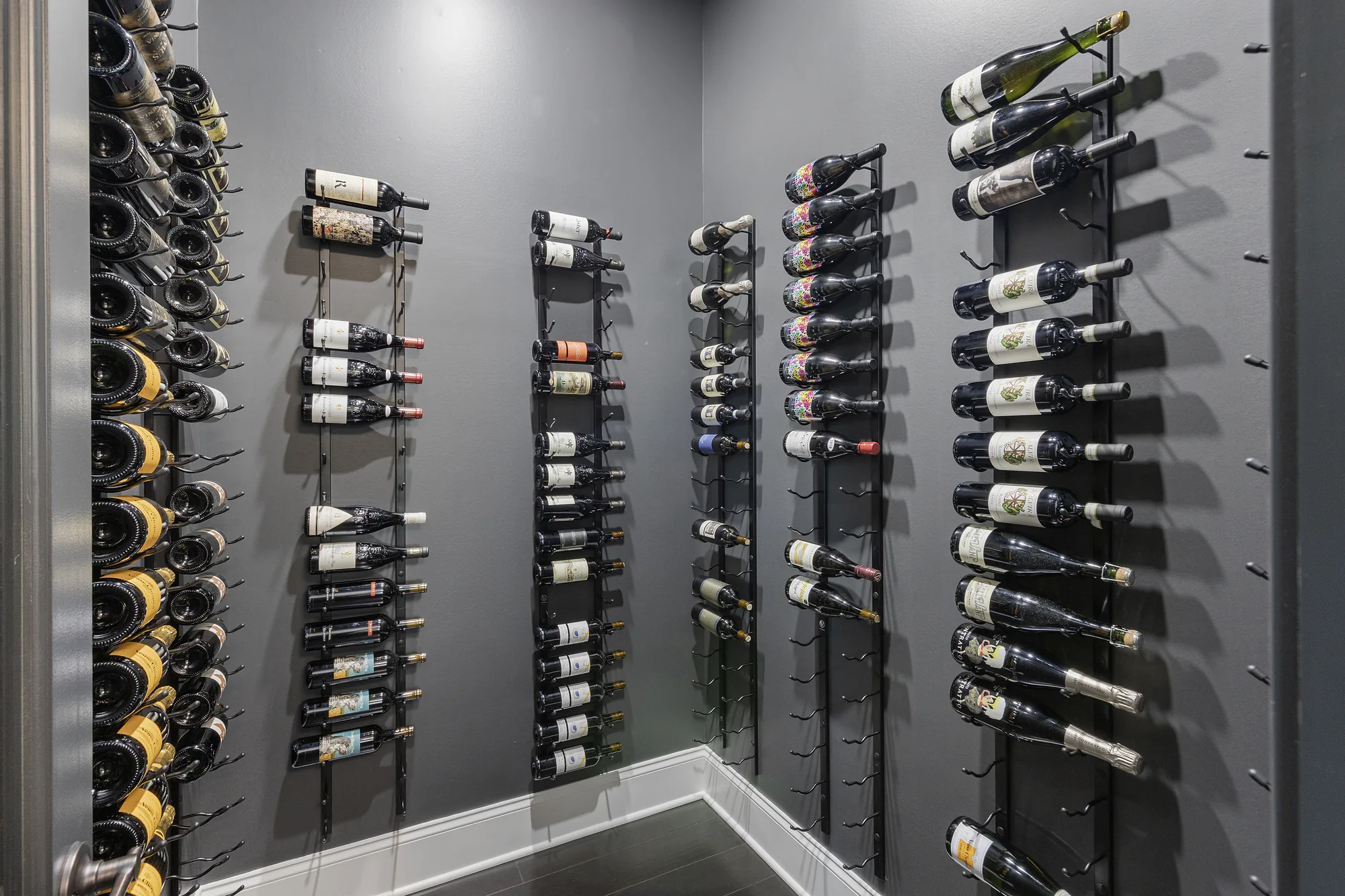 Custom Venetia Wine Room Featuring Modern Minimalist Design with Floor-to-Ceiling Metal Wine Racks, Climate Controlled System Perfect for Intimate Wine
Tasting Parties