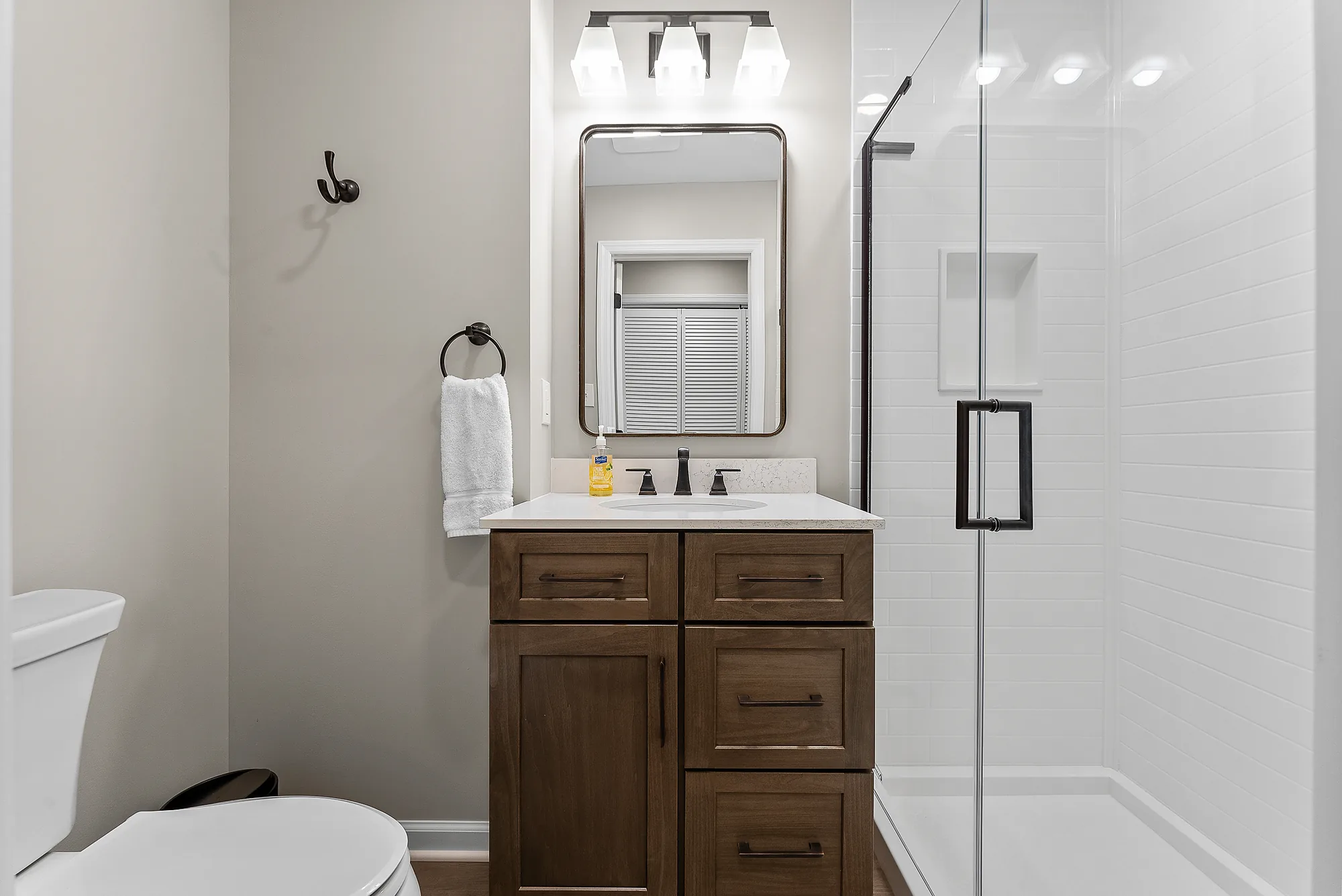 Custom Wexford Guest Bathroom with Spacious Walk
-
In Shower Cove
red in Glass,
Warm Wood Vanity and Quartz Countertop.
