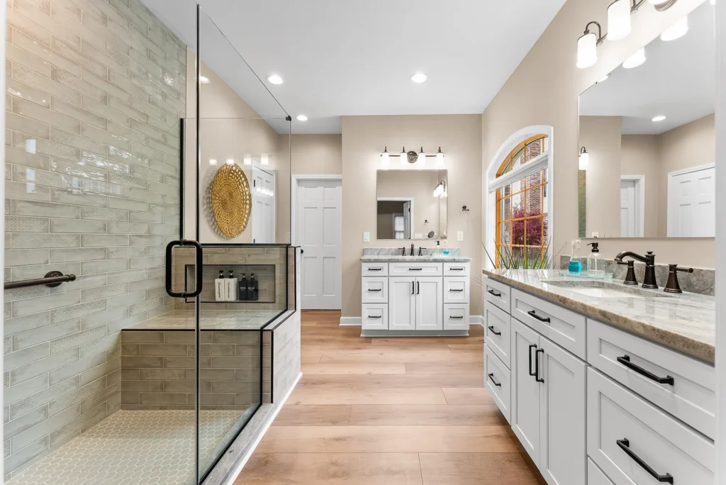Stunning Beaver Falls Master Bathroom Featuring a Large Walk - In Shower with Glass Enclosure, Built - In Bench and Custom Tile Surround.