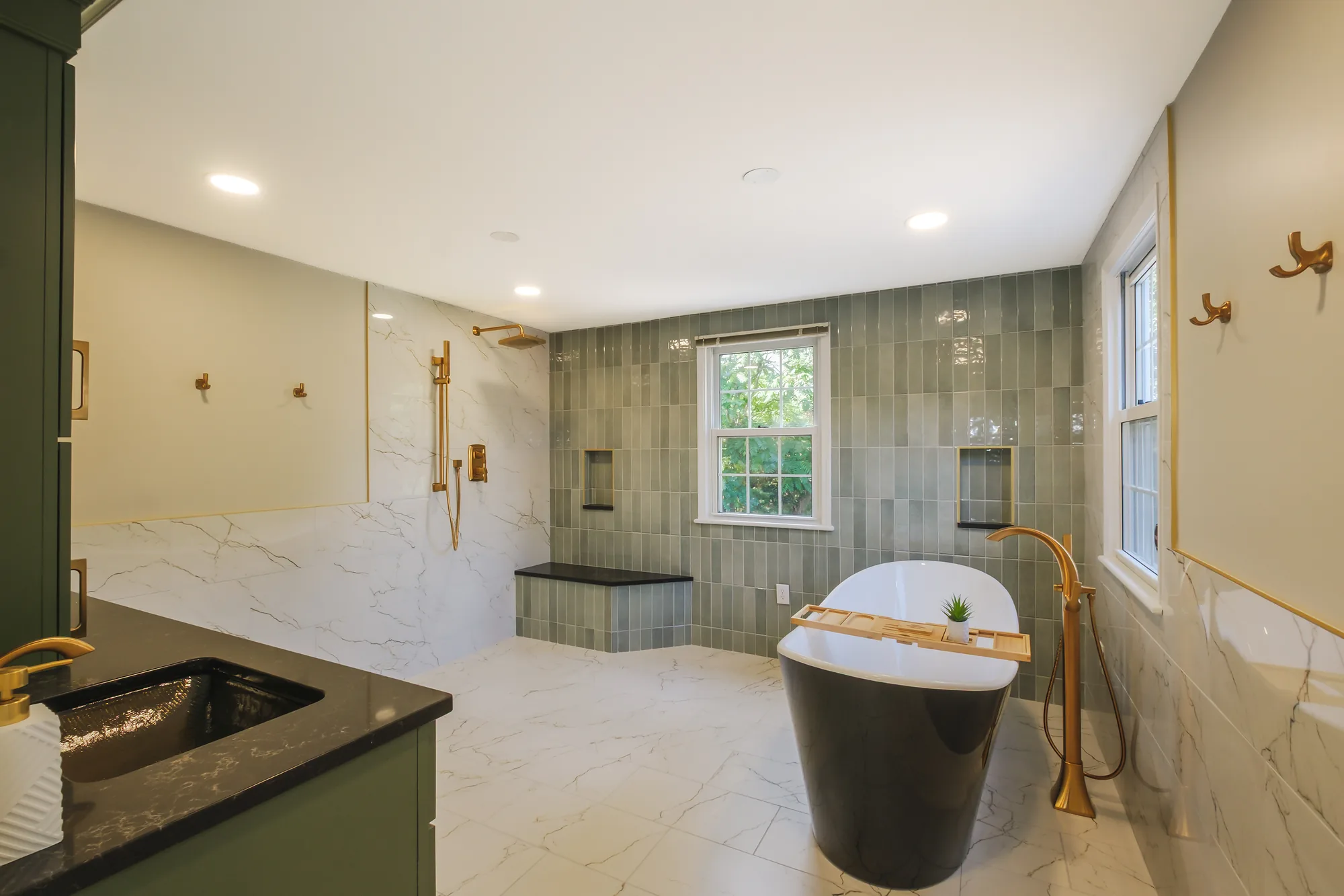 Modern, Luxurious Wexford Bathroom with Freestanding Black and White Tub Paired
with Gold Floor Mounted Tub Faucet