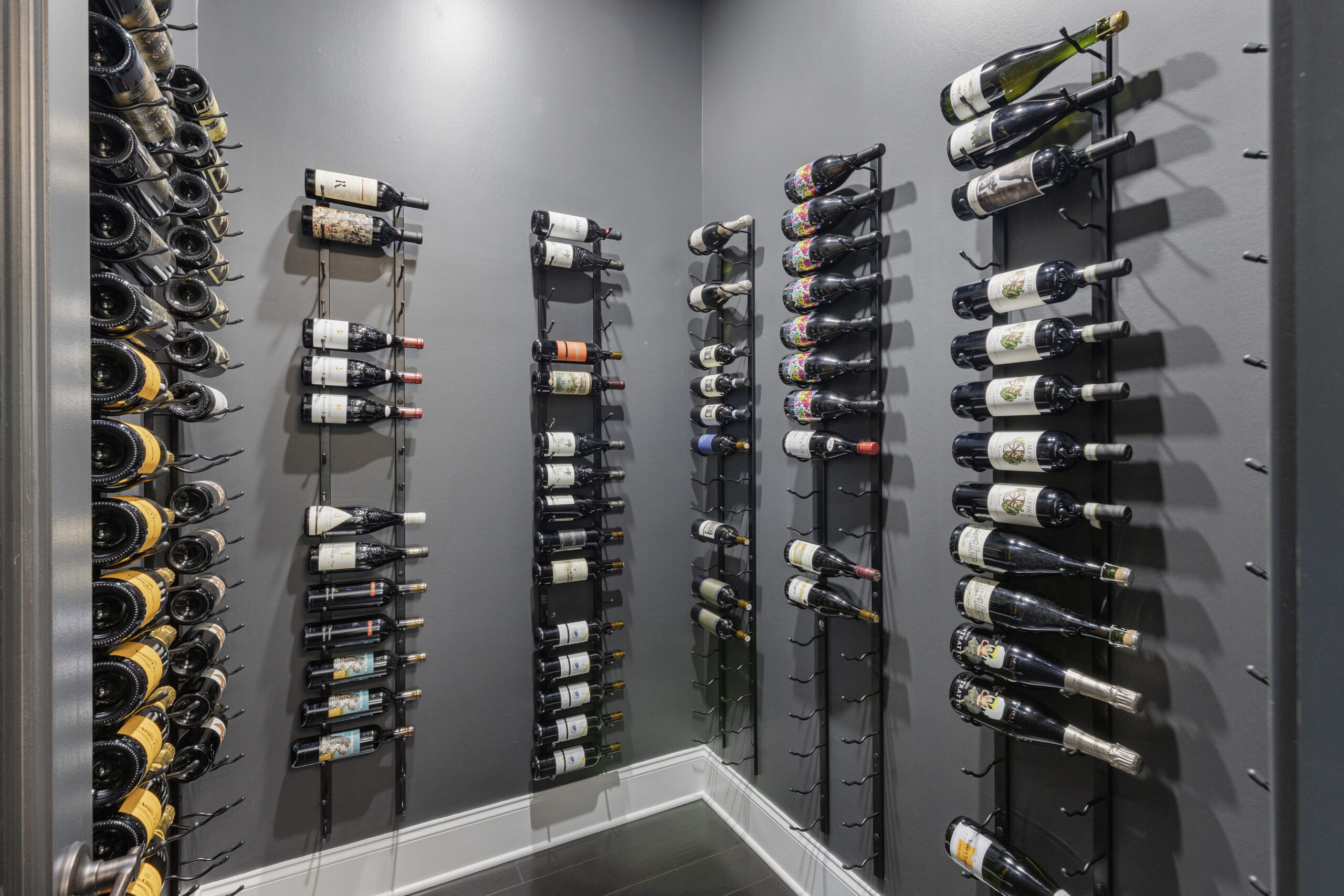 Custom Venetia wine room with floor-to-ceiling metal wine racks, refrigeration, and a climate-controlled system.