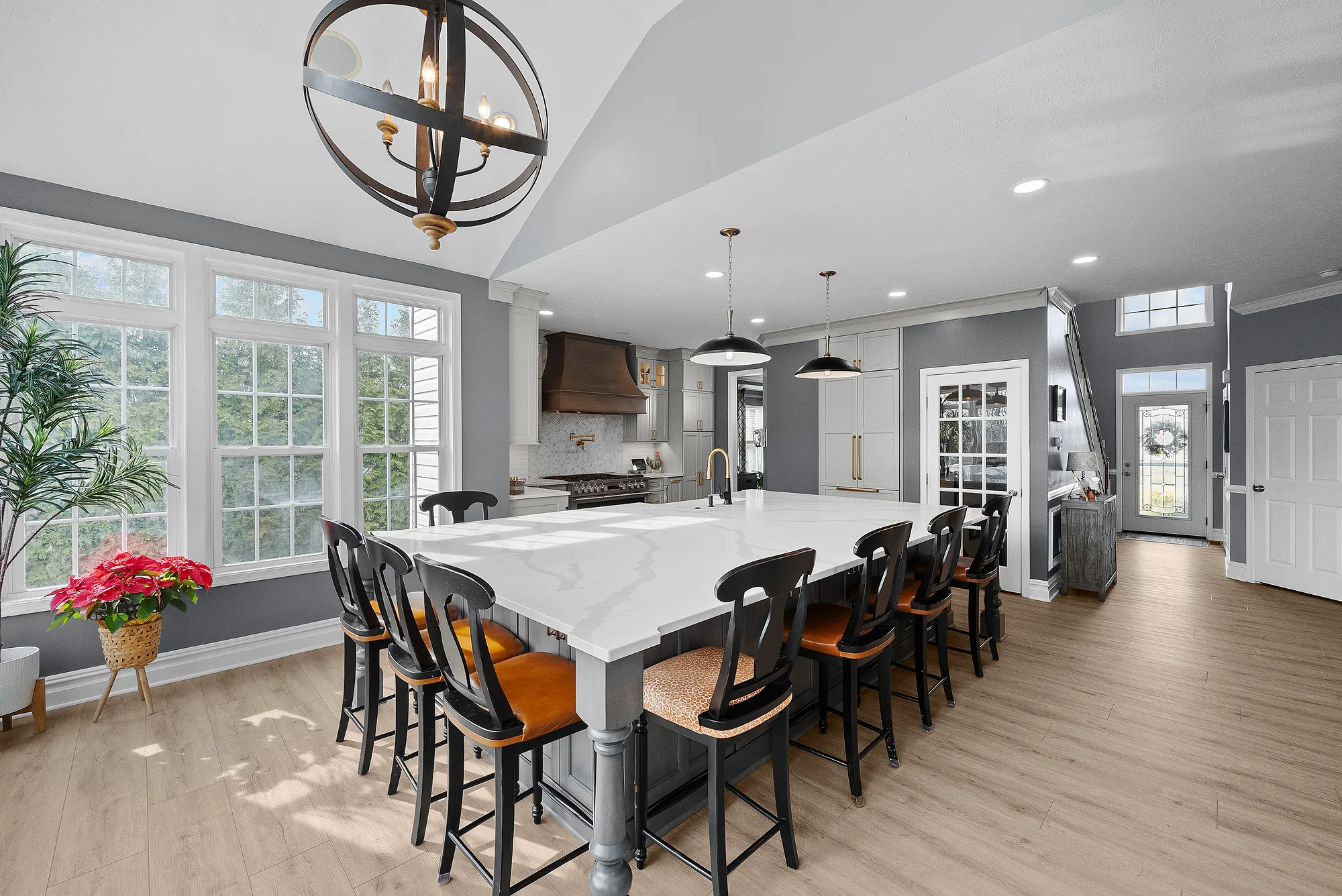 Bright Airy Baldwin Kitchen Showing a Light Quartz Countertop With Veining, Warm
Tone Luxury Vinyl Flooring and Large Gray Island
