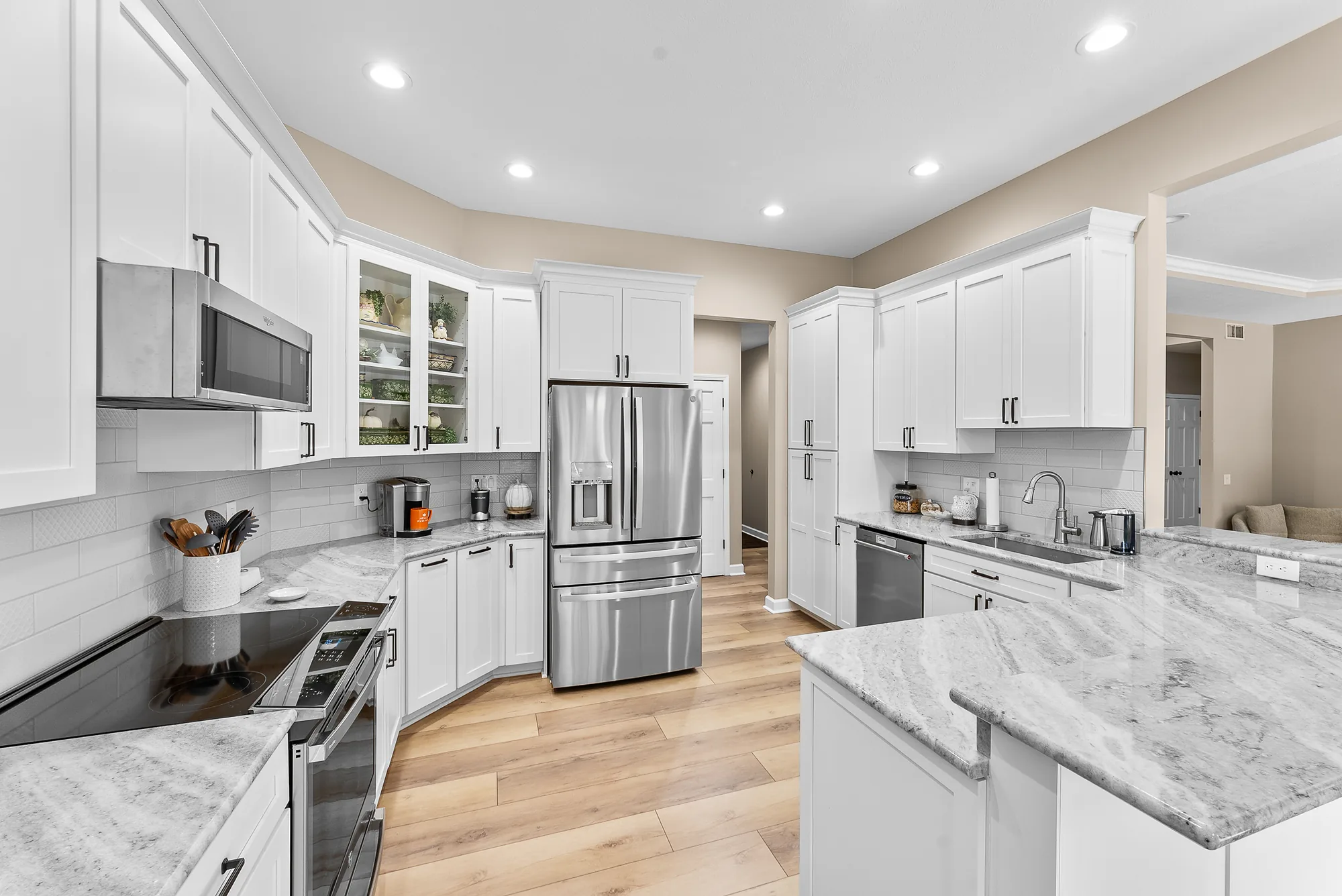 Modern Beaver Falls Kitchen Showing White Shaker
-
Style Cabinets, White Granite
Countertops, White Subway Backsplash With Deco Ti
les and Light Wood Floor