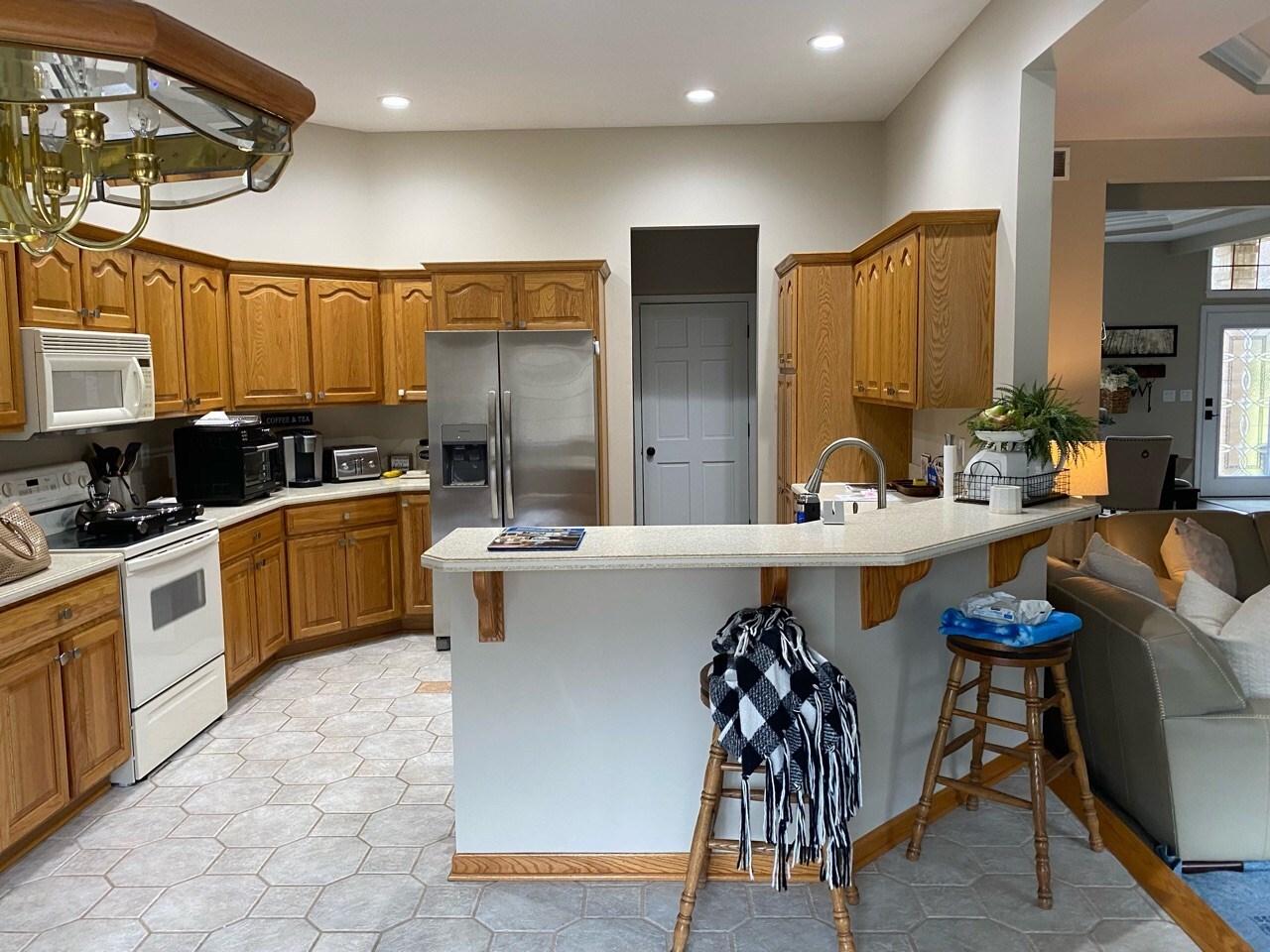 Before photo of the original Beaver Falls kitchen with stained cabinets and limited storage before Pittsburgh's Best Remodeling.