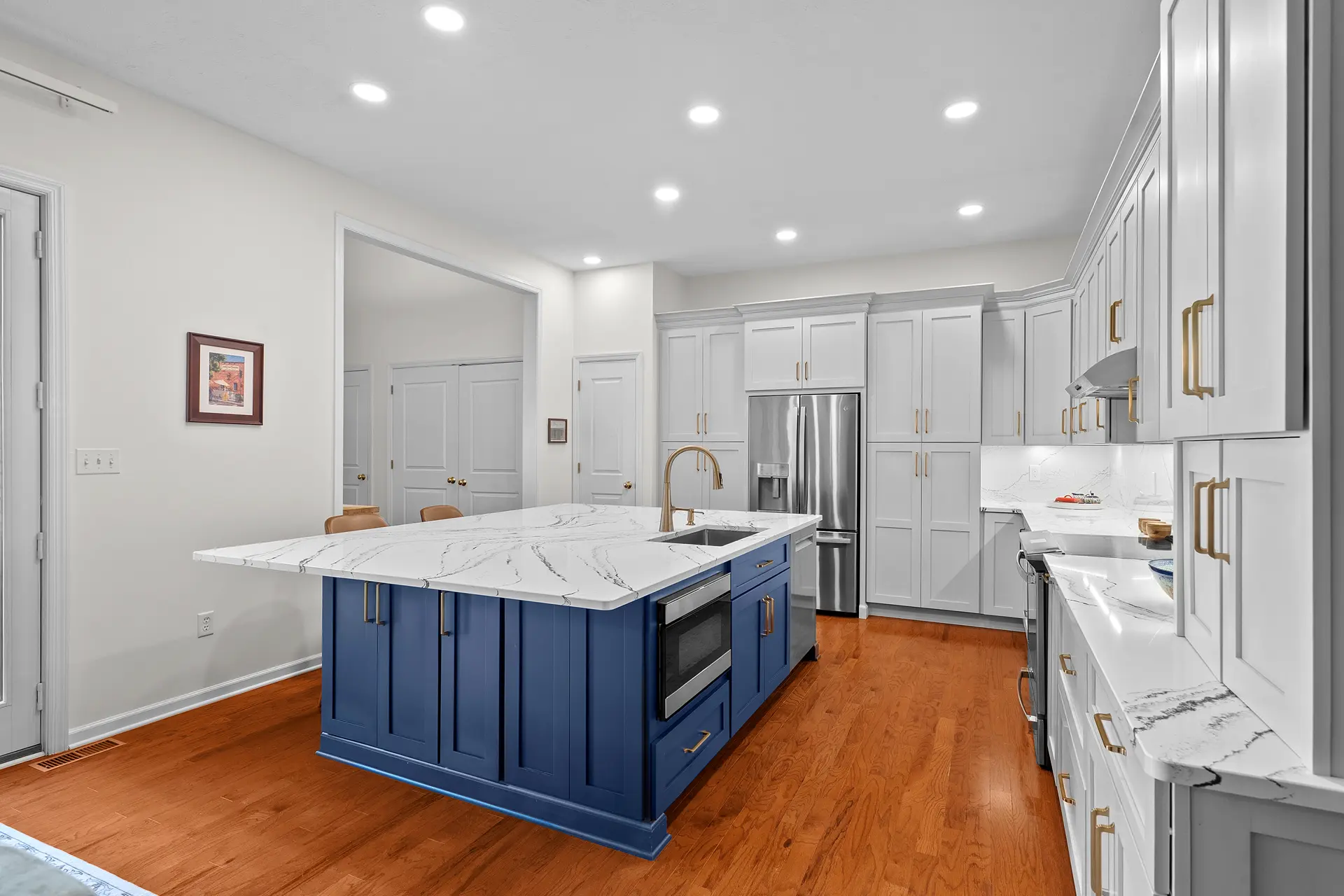 White Squirrel Hill Transitional Shaker-Style Kitchen with Blue Accent Island, White Quartz Countertops with Dark Gray Veining
