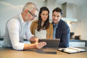 A couple looking over their home remodel design with the designer.