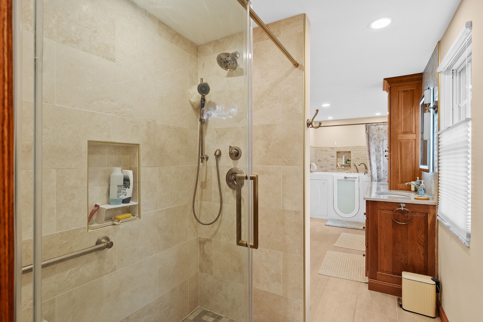 Ross Township master bathroom with custom wood vanity and stone finishes blending comfort and accessibility.