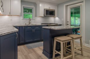 A Beautiful Kitchen using a two-tone color scheme for the painted cabinets. Warm tone on the floor helps neutralize the cold tone used in the counter tops.
