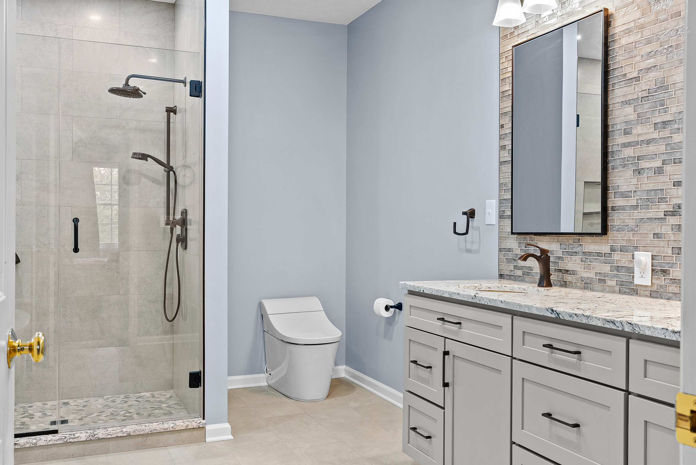 Contemporary Squirrel Hill Master Bathroom with Modern Spa-Inspired Style Featuring a Freestanding Soaking Tub with Sleek Dark Fixtures and Frameless Glass Walk-In Shower