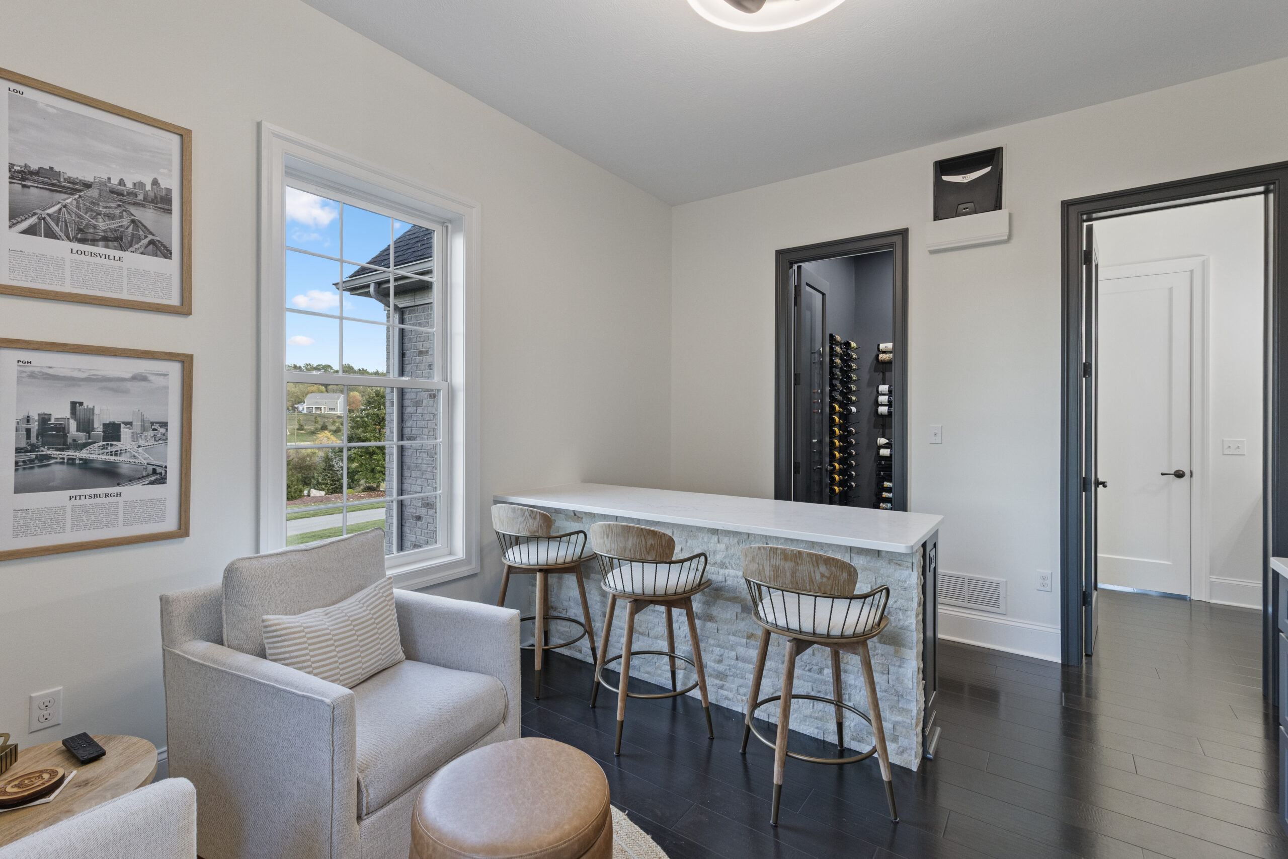 Custom Venetia Wine Room Featuring a Modern Minimalist Design with Floor-to- Ceiling Metal Wine Racks and Refrigeration and Climate Controlled System Perfect for Intimate Wine Tasting Parties
