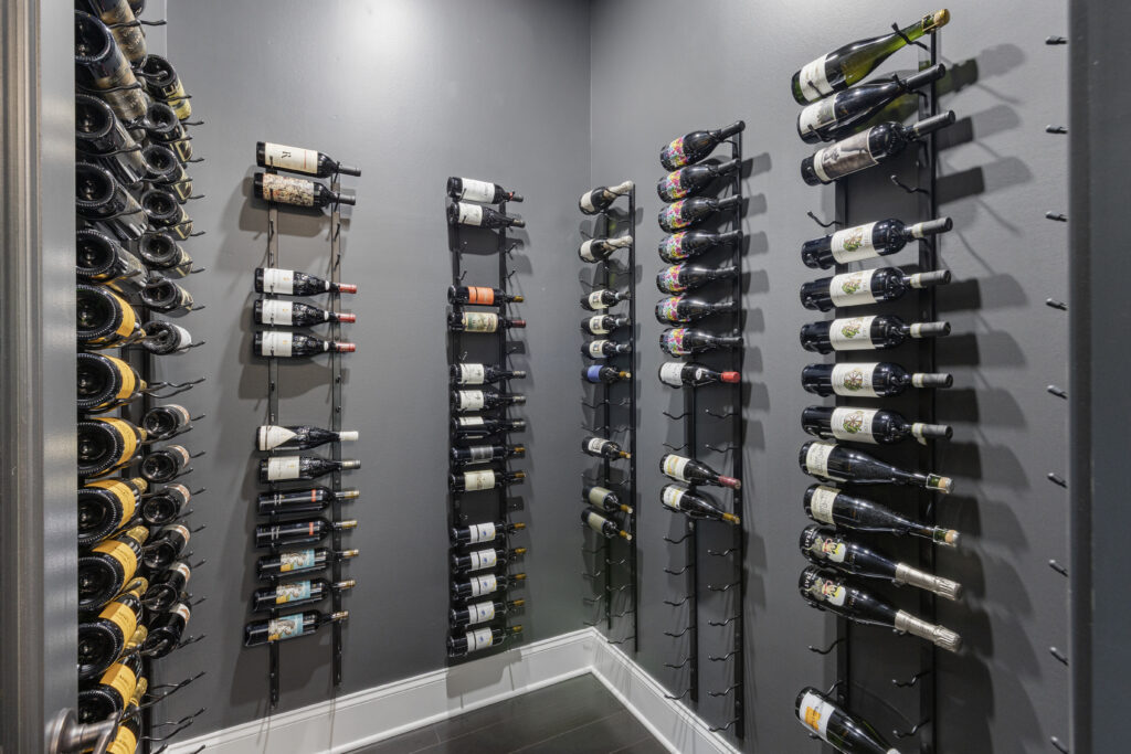 Custom Venetia Wine Room Featuring a Modern Minimalist Design with Floor-to- Ceiling Metal Wine Racks and Refrigeration and Climate Controlled System Perfect for Intimate Wine Tasting Parties